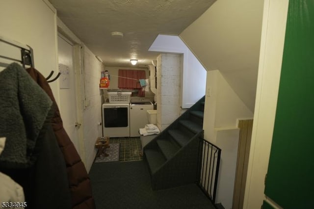 hall featuring washer and clothes dryer and a textured ceiling