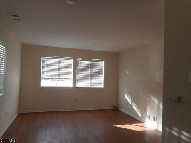 unfurnished room with dark hardwood / wood-style floors