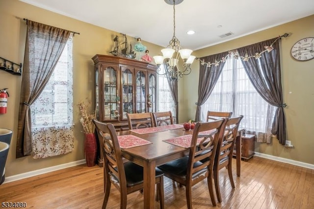 dining room featuring light hardwood / wood-style flooring, a chandelier, and plenty of natural light