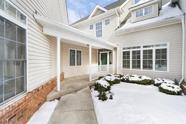 view of snow covered property entrance