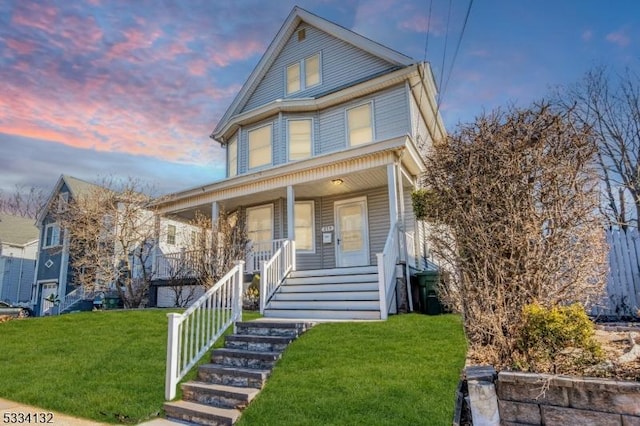 view of front facade with a yard and covered porch