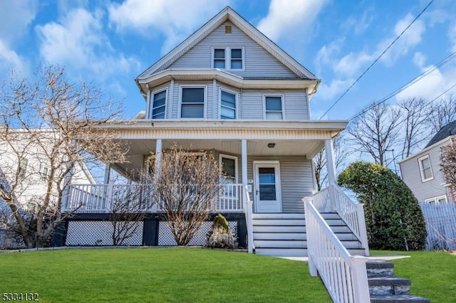 view of front of home with a porch and a front yard