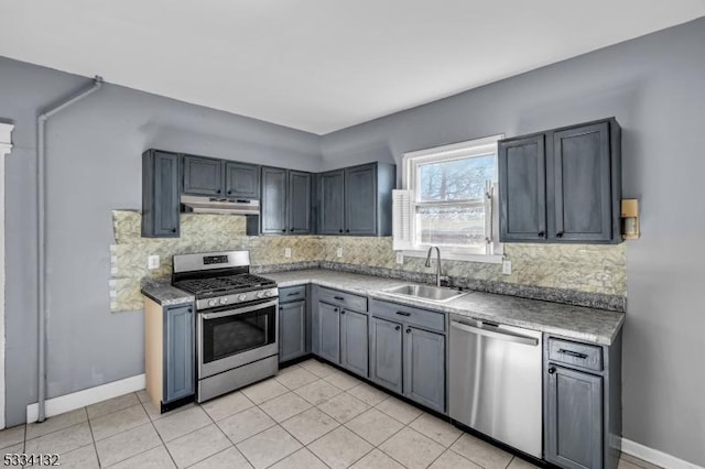 kitchen with sink, gray cabinetry, stainless steel appliances, tasteful backsplash, and light tile patterned flooring