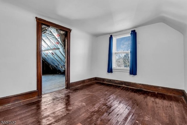 bonus room with hardwood / wood-style flooring and vaulted ceiling