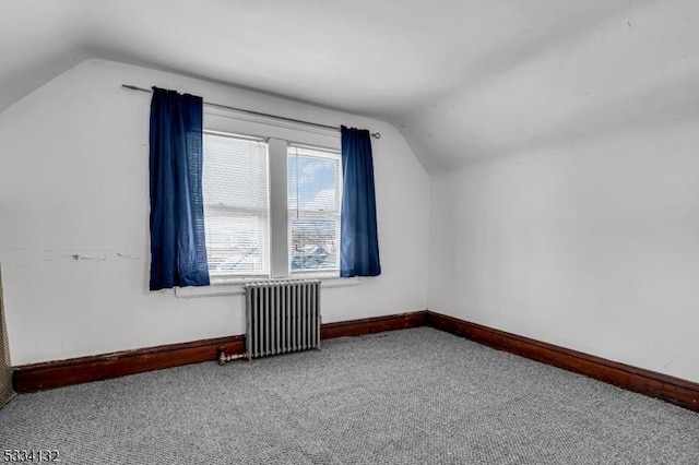 bonus room featuring lofted ceiling, radiator, and carpet flooring