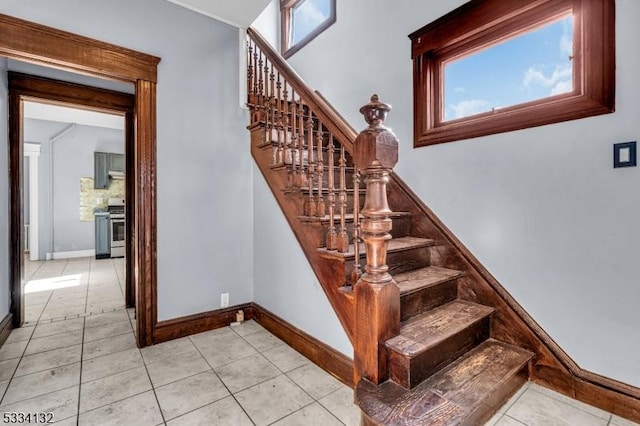 staircase featuring tile patterned flooring