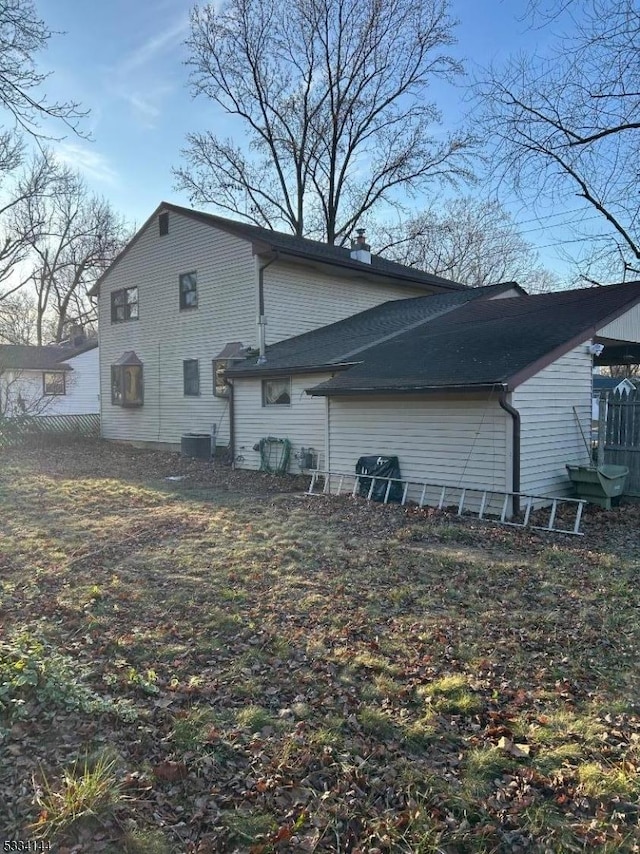 rear view of property with central air condition unit