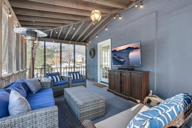 living room with track lighting and beamed ceiling