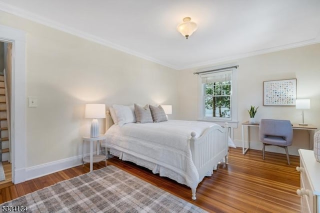 bedroom with ornamental molding and wood-type flooring