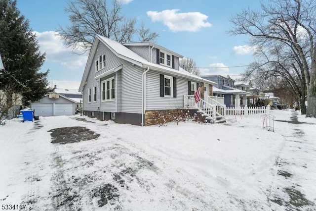 view of front of property featuring a garage and an outdoor structure