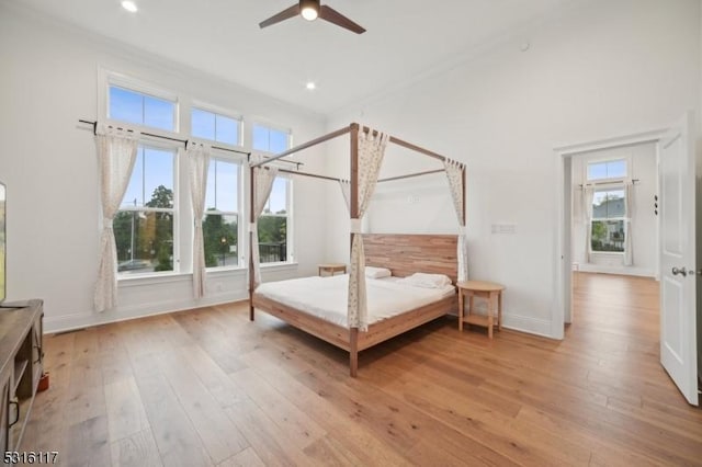 unfurnished bedroom with crown molding, light wood-type flooring, and ceiling fan