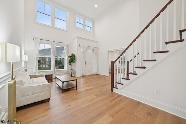 foyer entrance featuring a high ceiling and light hardwood / wood-style floors