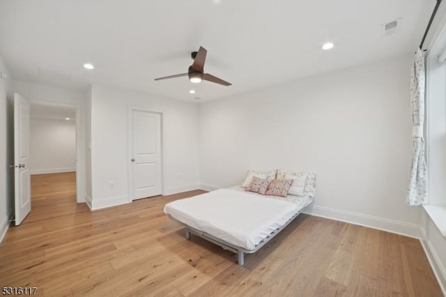 bedroom with ceiling fan and light hardwood / wood-style floors