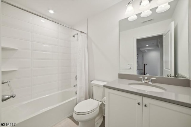 full bathroom featuring shower / tub combo with curtain, vanity, and toilet