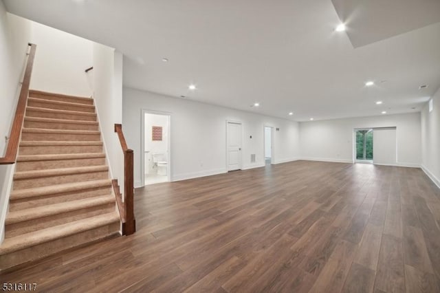 unfurnished living room with dark wood-type flooring