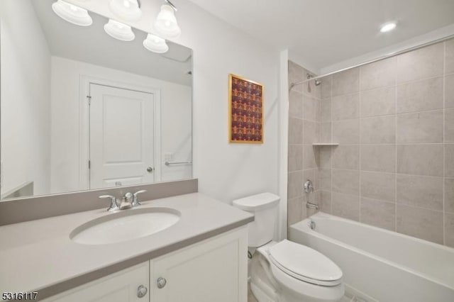 full bathroom with vanity, toilet, and tiled shower / bath combo