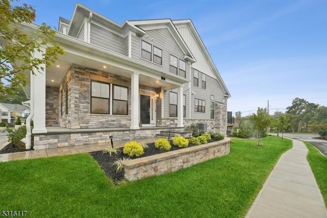 view of side of property with a porch and a yard