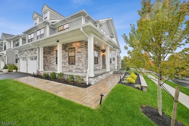 view of home's exterior featuring a porch, a garage, and a lawn