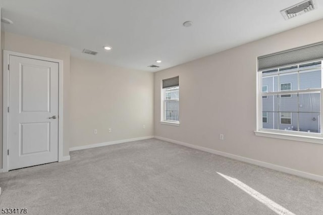 unfurnished room with light colored carpet