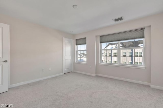 carpeted empty room with a wealth of natural light