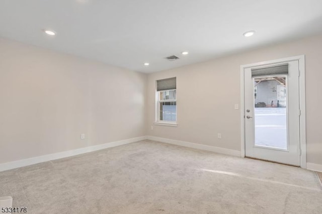 spare room with light colored carpet