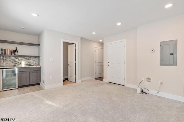 bar featuring wine cooler, light colored carpet, and electric panel