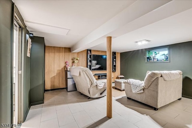 living area with light tile patterned flooring and wooden walls