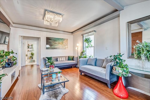 living room with hardwood / wood-style floors and a notable chandelier