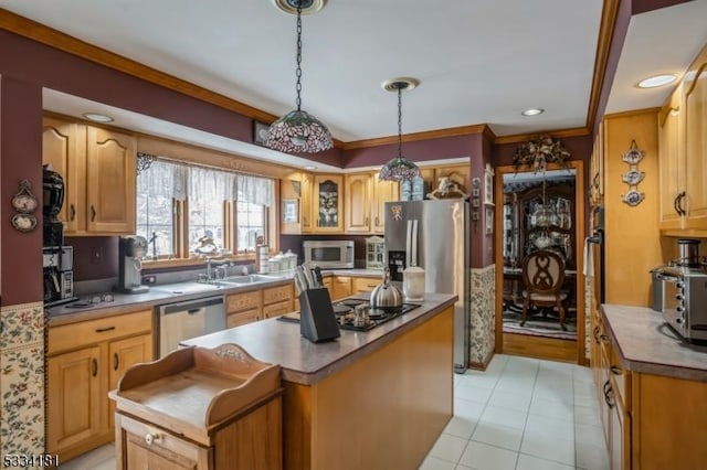 kitchen with sink, hanging light fixtures, a center island, light tile patterned floors, and stainless steel appliances