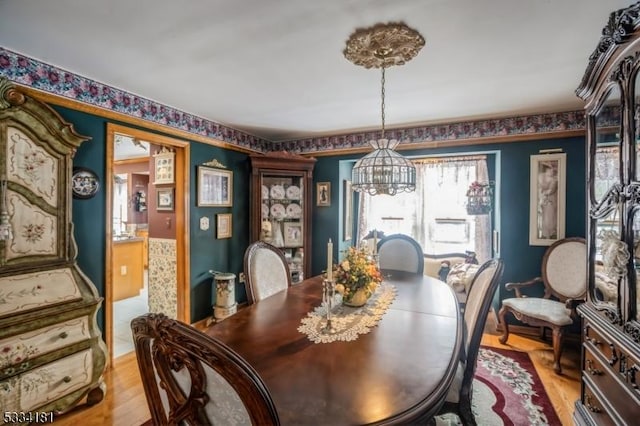 dining room featuring a notable chandelier and light hardwood / wood-style floors