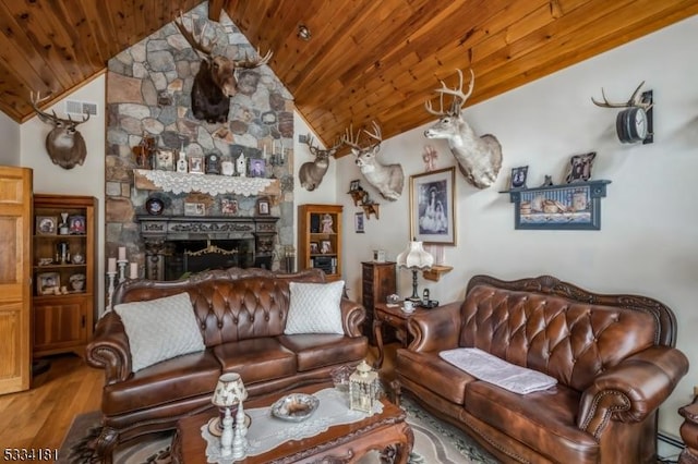 living room with lofted ceiling, wooden ceiling, a fireplace, hardwood / wood-style floors, and a baseboard heating unit