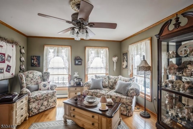 sitting room featuring a baseboard radiator, ceiling fan, crown molding, and light hardwood / wood-style flooring