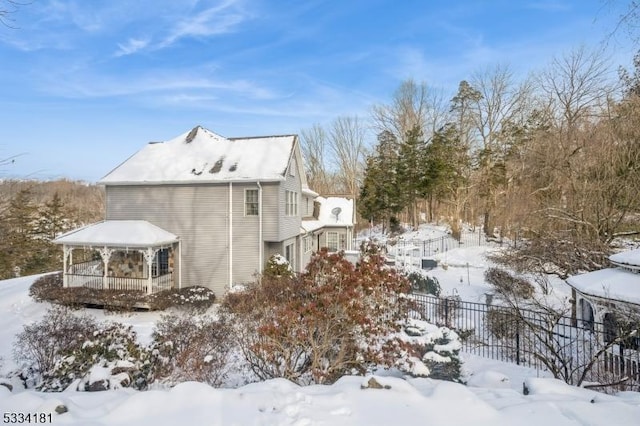 view of snow covered exterior featuring a gazebo