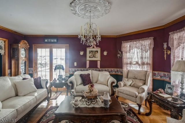 living room featuring a notable chandelier and ornamental molding