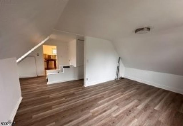 bonus room featuring dark hardwood / wood-style floors and lofted ceiling