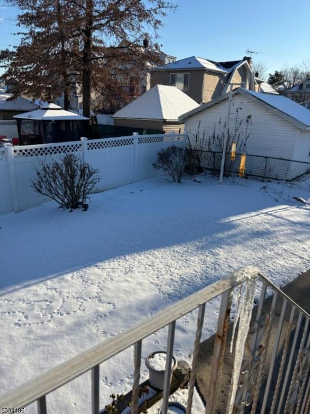 view of yard layered in snow