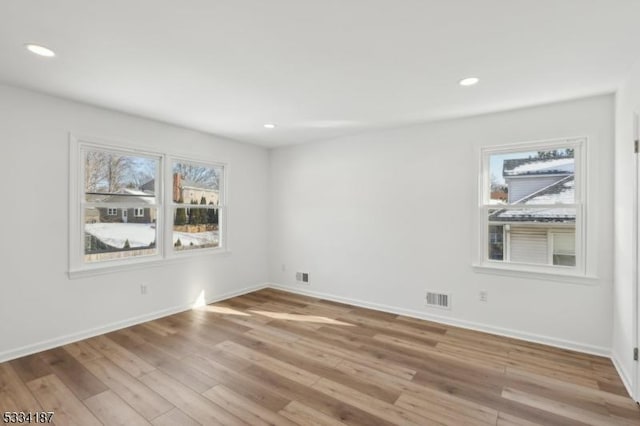 empty room with light hardwood / wood-style floors