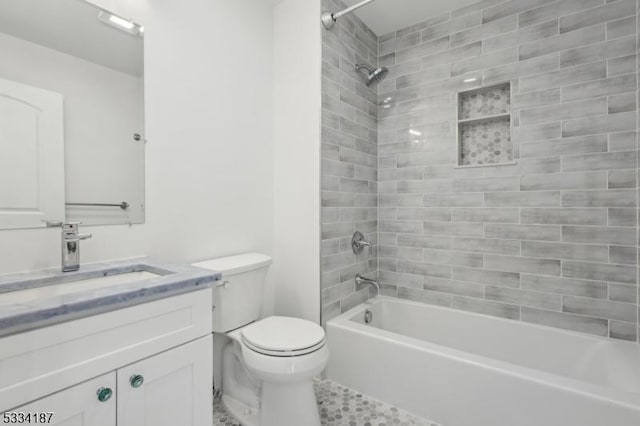 full bathroom with vanity, toilet, and tiled shower / bath combo