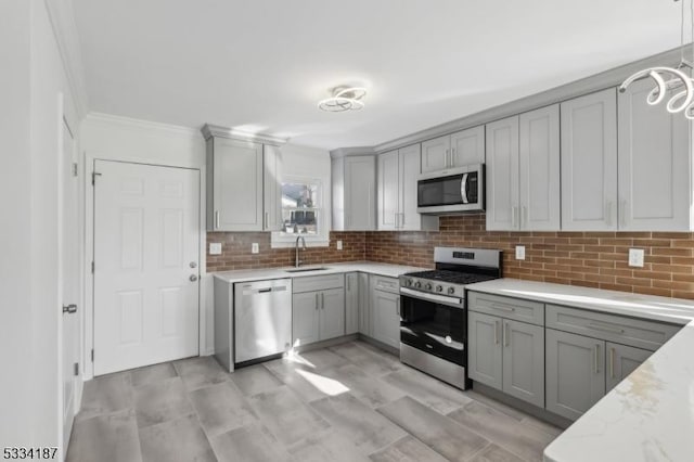 kitchen with stainless steel appliances, tasteful backsplash, and gray cabinets