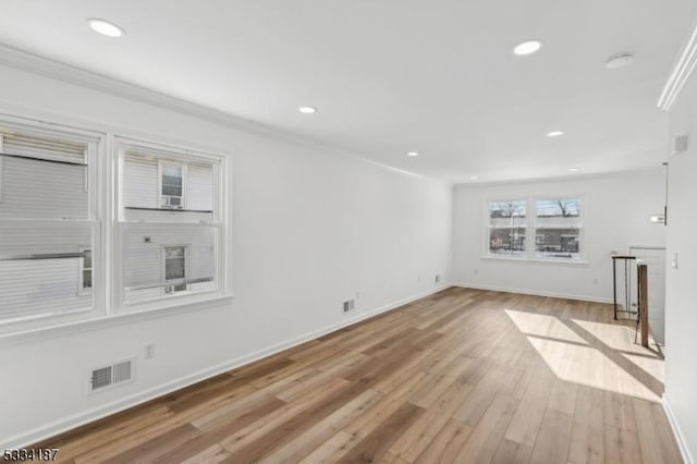 unfurnished living room with ornamental molding and light hardwood / wood-style flooring