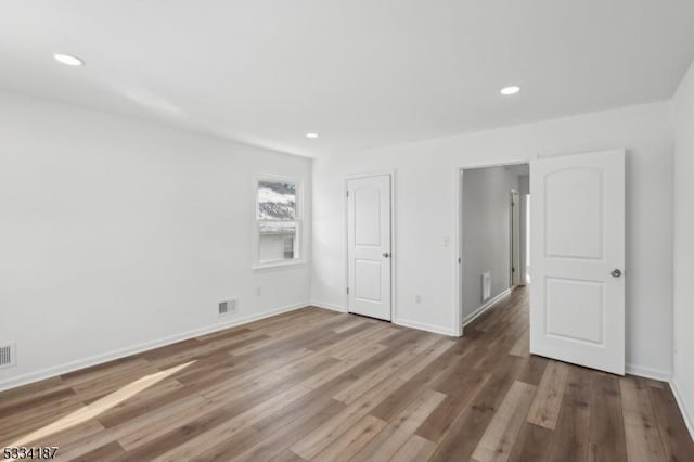 spare room with wood-type flooring