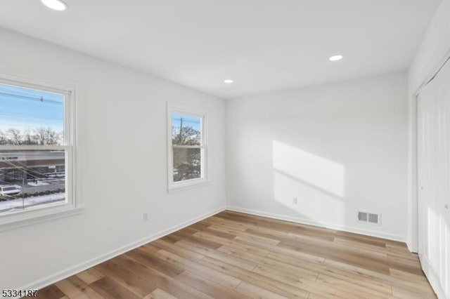 unfurnished room with light hardwood / wood-style floors