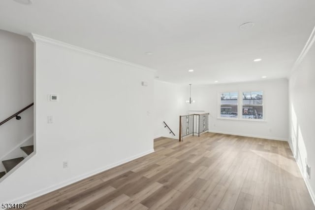 unfurnished living room with crown molding and light wood-type flooring