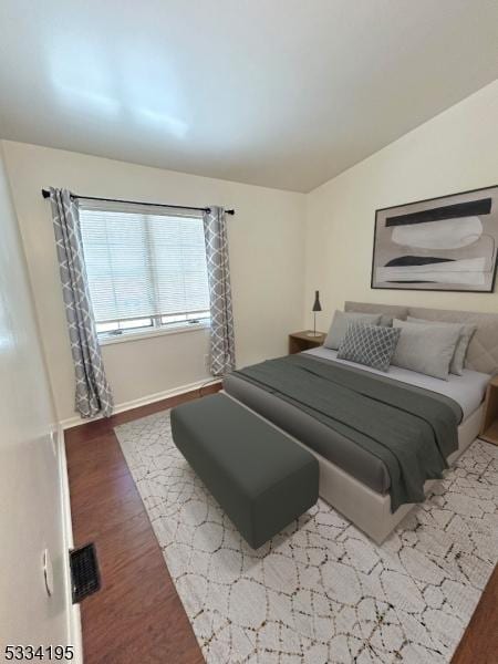 bedroom with hardwood / wood-style floors