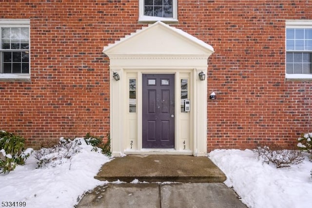 view of snow covered property entrance