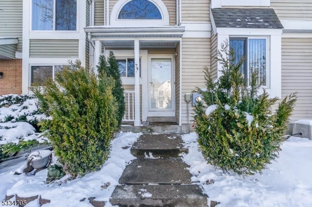 view of snow covered property entrance