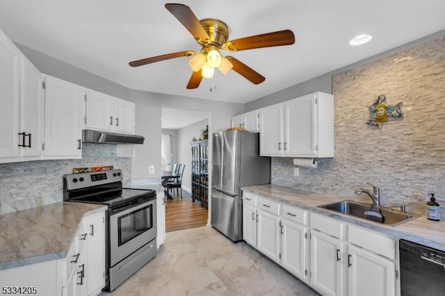 kitchen featuring white cabinetry, stainless steel appliances, sink, and decorative backsplash