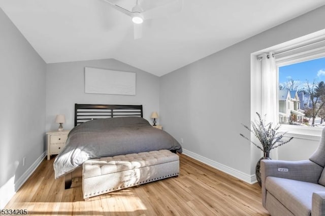 bedroom featuring lofted ceiling, light wood-type flooring, and ceiling fan