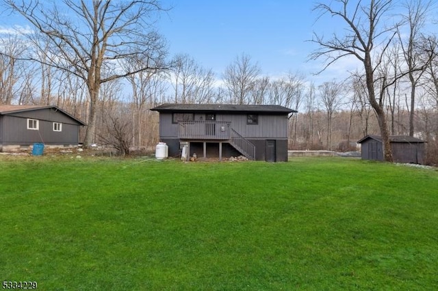 back of property featuring a storage shed, a yard, and a deck