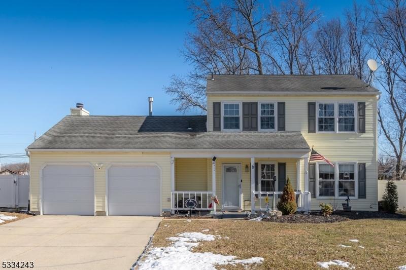 view of front of home with a porch, a garage, and a front lawn